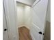View of an empty walk-in closet with hardwood floors and white walls, offering ample storage space at 1059 Dryden Ln # 11, Atlanta, GA 30319