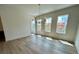 Bright dining room with wood floors, modern lighting, and windows with backyard views at 1059 Dryden Ln # 11, Atlanta, GA 30319