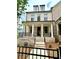 Beautiful light brick two story home features a welcoming front porch and black wrought iron fencing at 1059 Dryden Ln # 11, Atlanta, GA 30319