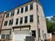 Lovely light brick townhome featuring an attached garage and covered pergola at 1059 Dryden Ln # 11, Atlanta, GA 30319