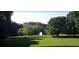 Lush green lawn with trees, walking paths, and a peaceful pond setting at 1059 Dryden Ln # 11, Atlanta, GA 30319