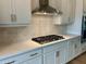 Beautiful kitchen featuring white countertops, a stainless steel range hood and tiled backsplash at 1059 Dryden Ln # 11, Atlanta, GA 30319