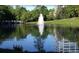 Scenic pond with a fountain surrounded by lush greenery and a reflection of a nearby building at 1059 Dryden Ln # 11, Atlanta, GA 30319