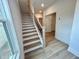 View of a modern staircase with wooden treads, white risers, and a black metal railing at 1059 Dryden Ln # 11, Atlanta, GA 30319