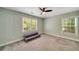 Bright bedroom with plush carpet, ceiling fan, and two large windows at 1535 Deerwood Dr, Decatur, GA 30030