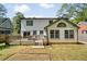 Home exterior features a large deck, sliding glass doors, and an expansive backyard with lush trees at 1535 Deerwood Dr, Decatur, GA 30030