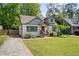 Charming bungalow home featuring a well-manicured lawn and inviting front porch at 1535 Deerwood Dr, Decatur, GA 30030