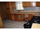 Kitchen with tile backsplash and wooden cabinets at 1646 Hurt Sw Rd, Marietta, GA 30008