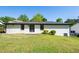 View of the backyard with grass and a white home with black trim, plus a set of double doors at 3719 Paul St, Douglasville, GA 30135
