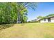 Backyard with a large lawn and mature foliage at 3719 Paul St, Douglasville, GA 30135