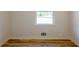 Bedroom featuring new wood flooring, a bright window, and freshly painted neutral walls at 3719 Paul St, Douglasville, GA 30135