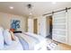 Bedroom featuring a sliding barn door, leading to an en-suite bathroom at 3719 Paul St, Douglasville, GA 30135