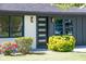 Close-up of a home's modern front door, garden and large picture windows at 3719 Paul St, Douglasville, GA 30135