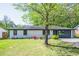 Inviting home featuring a lush green lawn and mature trees in a serene setting at 3719 Paul St, Douglasville, GA 30135