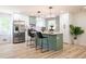 Contemporary kitchen with stainless steel appliances, green island, and modern light fixtures at 3719 Paul St, Douglasville, GA 30135