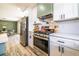 Modern kitchen featuring stainless steel appliances and a view into an adjacent dining area at 3719 Paul St, Douglasville, GA 30135
