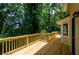 Inviting wooden deck offering a serene view of the surrounding greenery and mature trees at 4503 Rivercliff Sw Dr, Lilburn, GA 30047
