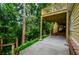 Back porch overlooking mature trees and lush landscaping at 4503 Rivercliff Sw Dr, Lilburn, GA 30047