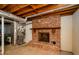 Basement featuring exposed beams and ductwork, concrete flooring, and a brick fireplace at 4503 Rivercliff Sw Dr, Lilburn, GA 30047