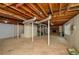 Unfinished basement with exposed beams, concrete flooring, a window and brick fireplace at 4503 Rivercliff Sw Dr, Lilburn, GA 30047