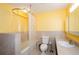 Bright bathroom with a tub/shower combination, neutral tile, and an oval shower rod and curtain at 4503 Rivercliff Sw Dr, Lilburn, GA 30047