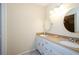 Bright bathroom featuring double vanity with granite counters, white cabinets and oval mirrors at 4503 Rivercliff Sw Dr, Lilburn, GA 30047
