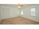 Bedroom featuring a closet, windows, and ceiling fan at 4503 Rivercliff Sw Dr, Lilburn, GA 30047