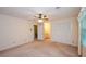 Bedroom with neutral walls, carpet and ceiling fan with bathroom entrance and window at 4503 Rivercliff Sw Dr, Lilburn, GA 30047