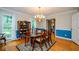 Elegant dining room featuring hardwood floors, a classic chandelier, and views of the backyard at 4503 Rivercliff Sw Dr, Lilburn, GA 30047