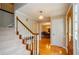 Inviting foyer with gleaming hardwood floors, staircase, and view into the dining room at 4503 Rivercliff Sw Dr, Lilburn, GA 30047