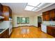 Eat-in kitchen boasting wooden cabinets, hardwood floors, and a bay window at 4503 Rivercliff Sw Dr, Lilburn, GA 30047