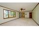 Bright living room featuring trim accents, ceiling fan, and a glass door out to the deck at 4503 Rivercliff Sw Dr, Lilburn, GA 30047