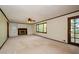 Spacious living room with built-in bookshelves, fireplace, and access to a deck at 4503 Rivercliff Sw Dr, Lilburn, GA 30047