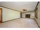 Spacious living room with built-in bookshelves, fireplace, and large window at 4503 Rivercliff Sw Dr, Lilburn, GA 30047