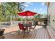 Back deck with table, chairs, an umbrella, and an outdoor cooking area at 5539 Hurstcliffe Nw Dr, Kennesaw, GA 30152