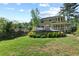 Spacious backyard featuring an above-ground pool, deck, mature trees, and a lawn at 5539 Hurstcliffe Nw Dr, Kennesaw, GA 30152