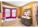 Bright bathroom boasting a soaking tub, vanity, and large picturesque window at 5539 Hurstcliffe Nw Dr, Kennesaw, GA 30152