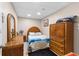 Cozy bedroom featuring a queen-sized bed, oak dresser, and carpet flooring at 5539 Hurstcliffe Nw Dr, Kennesaw, GA 30152