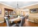 Dining room with hardwood flooring, and decorative chandelier at 5539 Hurstcliffe Nw Dr, Kennesaw, GA 30152