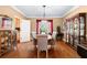 Formal dining room with hardwood floors, chandelier, and built-in china cabinets at 5539 Hurstcliffe Nw Dr, Kennesaw, GA 30152