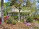 Charming home featuring a cozy porch, complemented by lush landscaping and vibrant azaleas at 5539 Hurstcliffe Nw Dr, Kennesaw, GA 30152