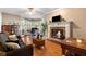 Cozy living room with a fireplace, bay window, and hardwood floors, offering a comfortable space to unwind at 5539 Hurstcliffe Nw Dr, Kennesaw, GA 30152