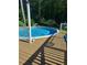 Inviting above ground pool with a wooden deck, perfect for summer relaxation and entertaining in a wooded setting at 5539 Hurstcliffe Nw Dr, Kennesaw, GA 30152