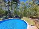Inviting in-ground pool surrounded by a wooden deck and lush greenery, perfect for relaxation at 5539 Hurstcliffe Nw Dr, Kennesaw, GA 30152
