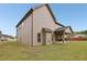 View of the backyard with a covered patio, showing the ample space and outdoor living potential at 811 Holly Mist Ct, Loganville, GA 30052