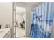 Bathroom featuring a dolphin shower curtain and view of home office at 811 Holly Mist Ct, Loganville, GA 30052