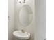 Bathroom features a pedestal sink, chrome faucet, and oval mirror at 811 Holly Mist Ct, Loganville, GA 30052