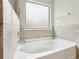 The bathtub features a sleek design with modern fixtures and tiled surround at 811 Holly Mist Ct, Loganville, GA 30052