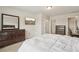 Carpeted bedroom featuring a dresser, TV, queen bed, and access to an ensuite bathroom at 811 Holly Mist Ct, Loganville, GA 30052
