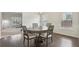 Dining room with hardwood floors, wainscoting, a modern chandelier and natural light at 811 Holly Mist Ct, Loganville, GA 30052